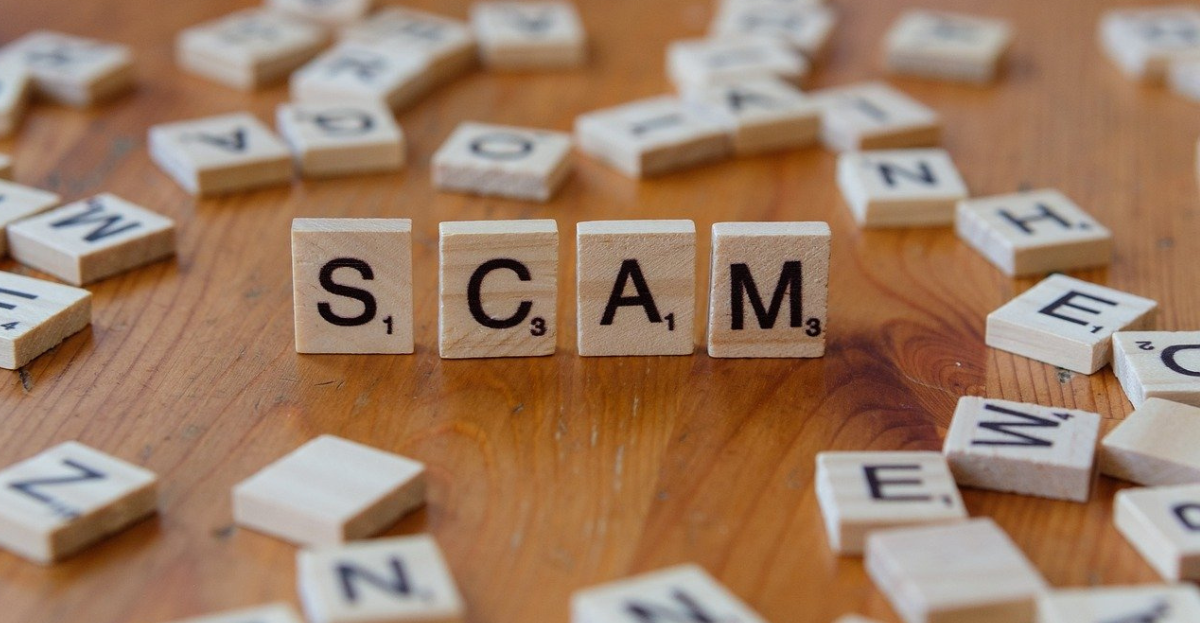 tiles spelling the word scam